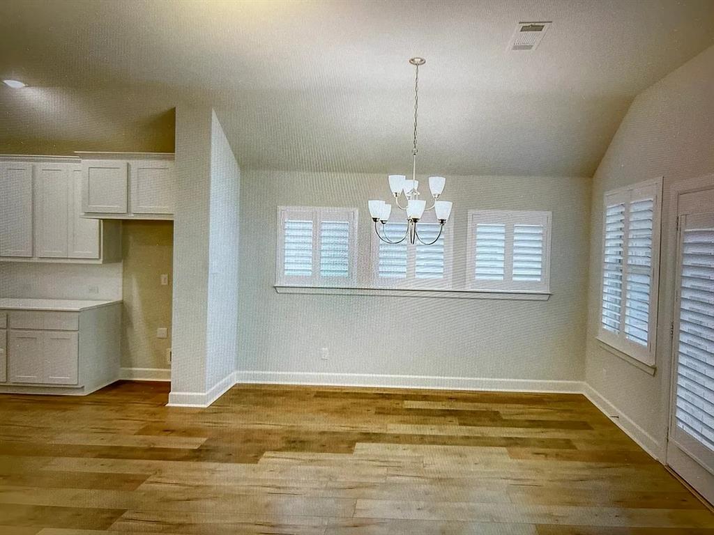 5541 Annie Creek Road Fort Worth, TX 76126 - Photo 6 of 8 a view of empty room with wooden floor and window