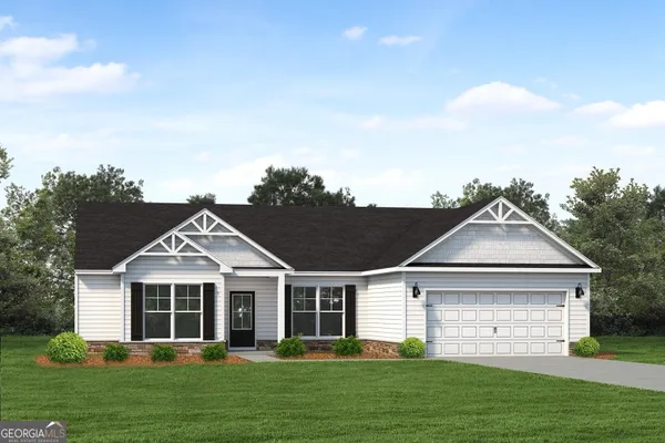 a front view of a house with a garden and trees