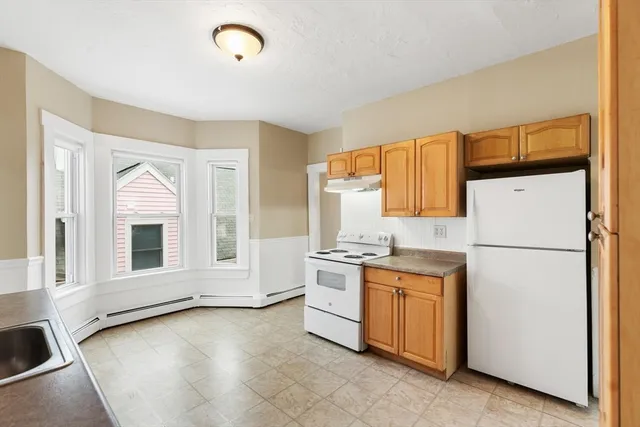 a view of a kitchen with a sink dishwasher and a refrigerator
