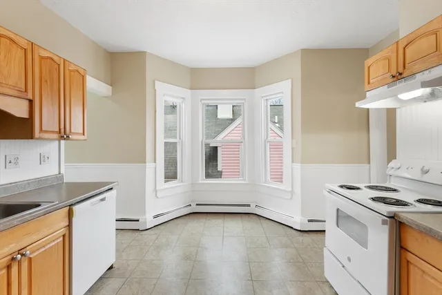 a kitchen with granite countertop a stove and a sink