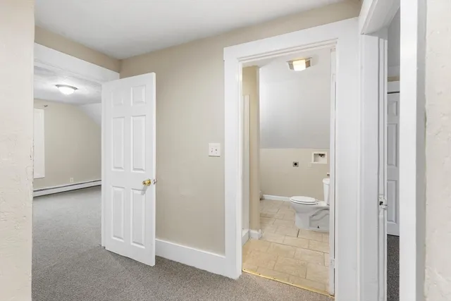 a bathroom with a granite countertop bathtub shower and toilet