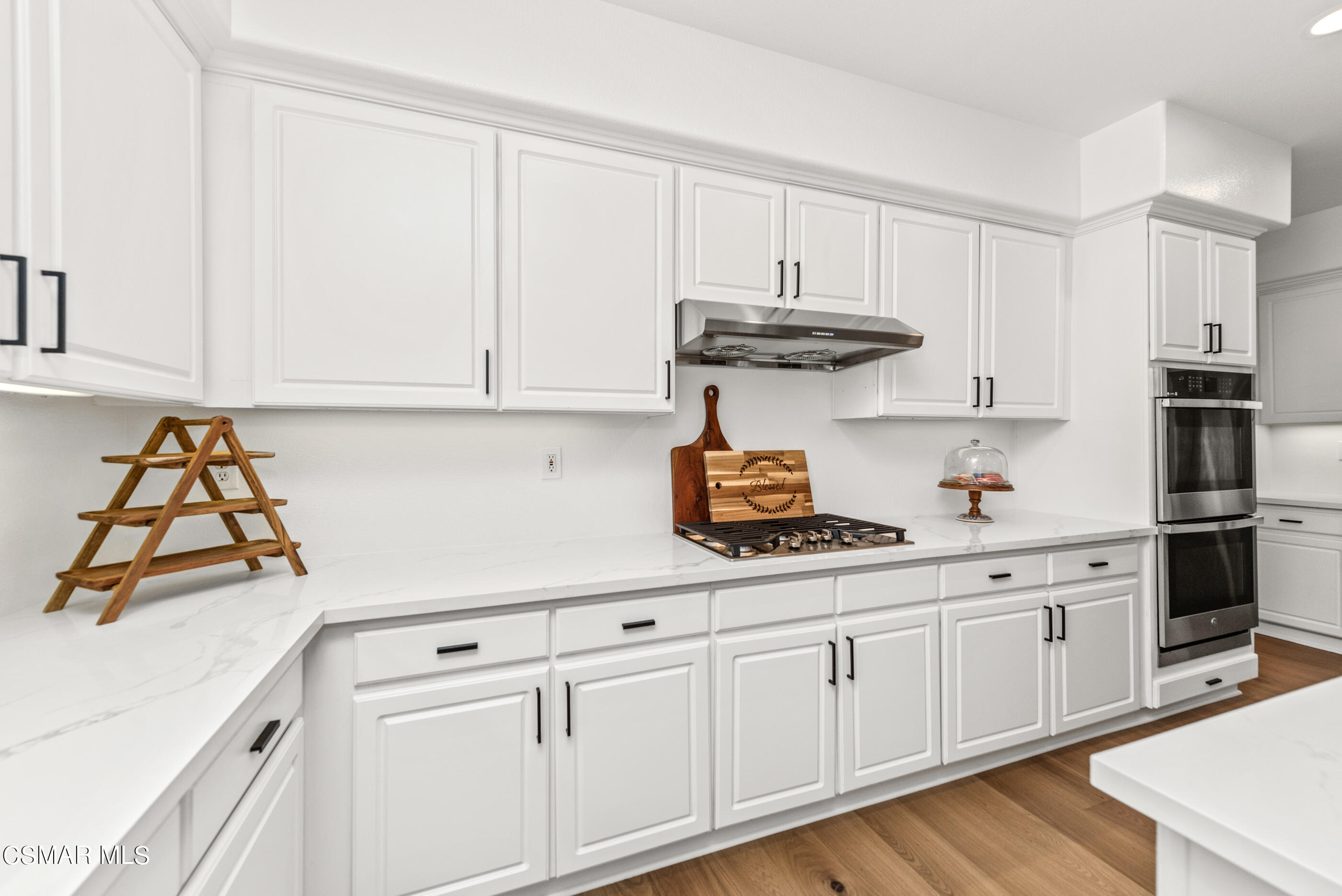 5984 Piuma Court Simi Valley, CA 93063 - Photo 24 of 70 a kitchen with white cabinets and white appliances