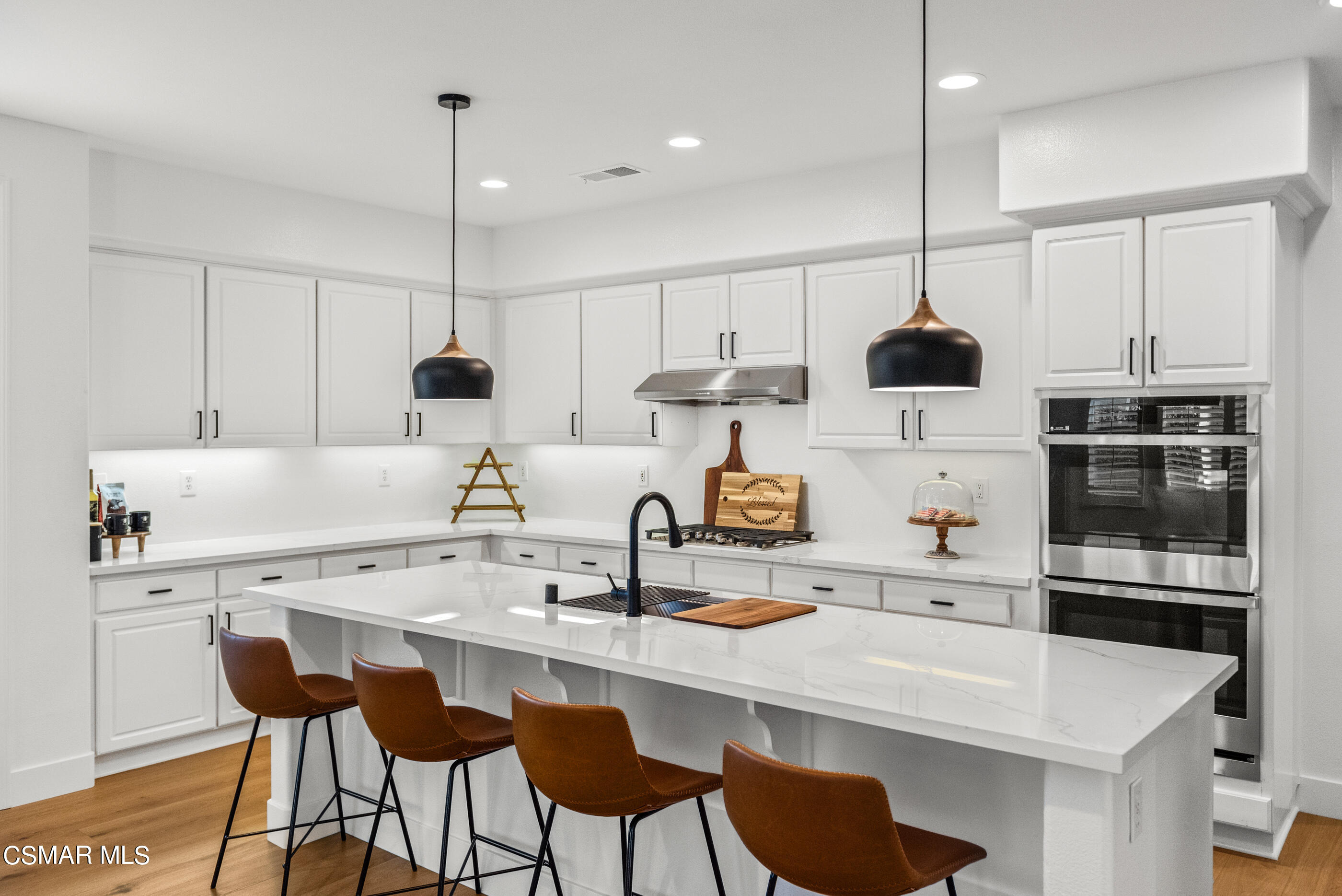 5984 Piuma Court Simi Valley, CA 93063 - Photo 27 of 70 a kitchen with a sink a counter and chairs