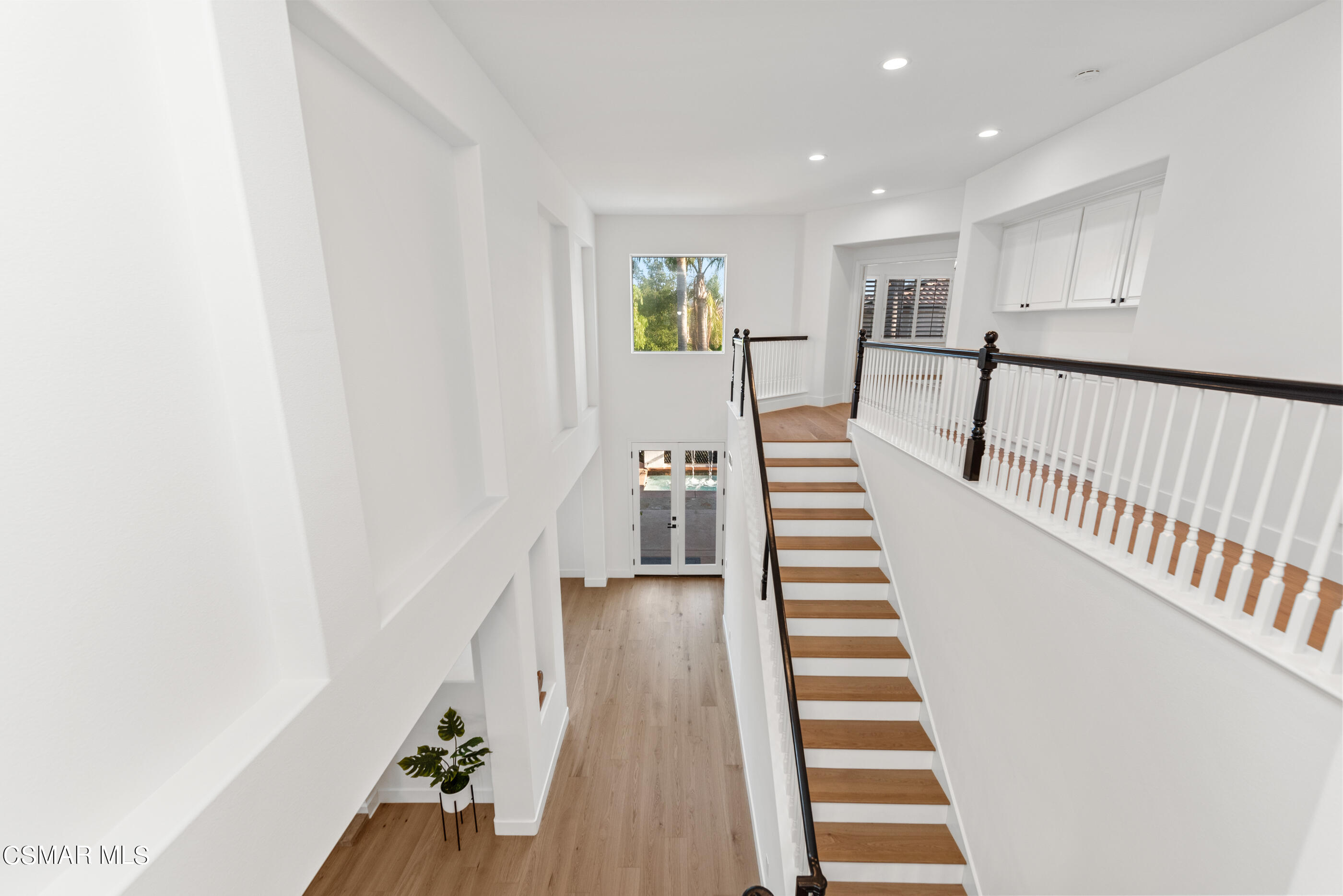 5984 Piuma Court Simi Valley, CA 93063 - Photo 42 of 70 a view of a hallway with wooden floor and stairs