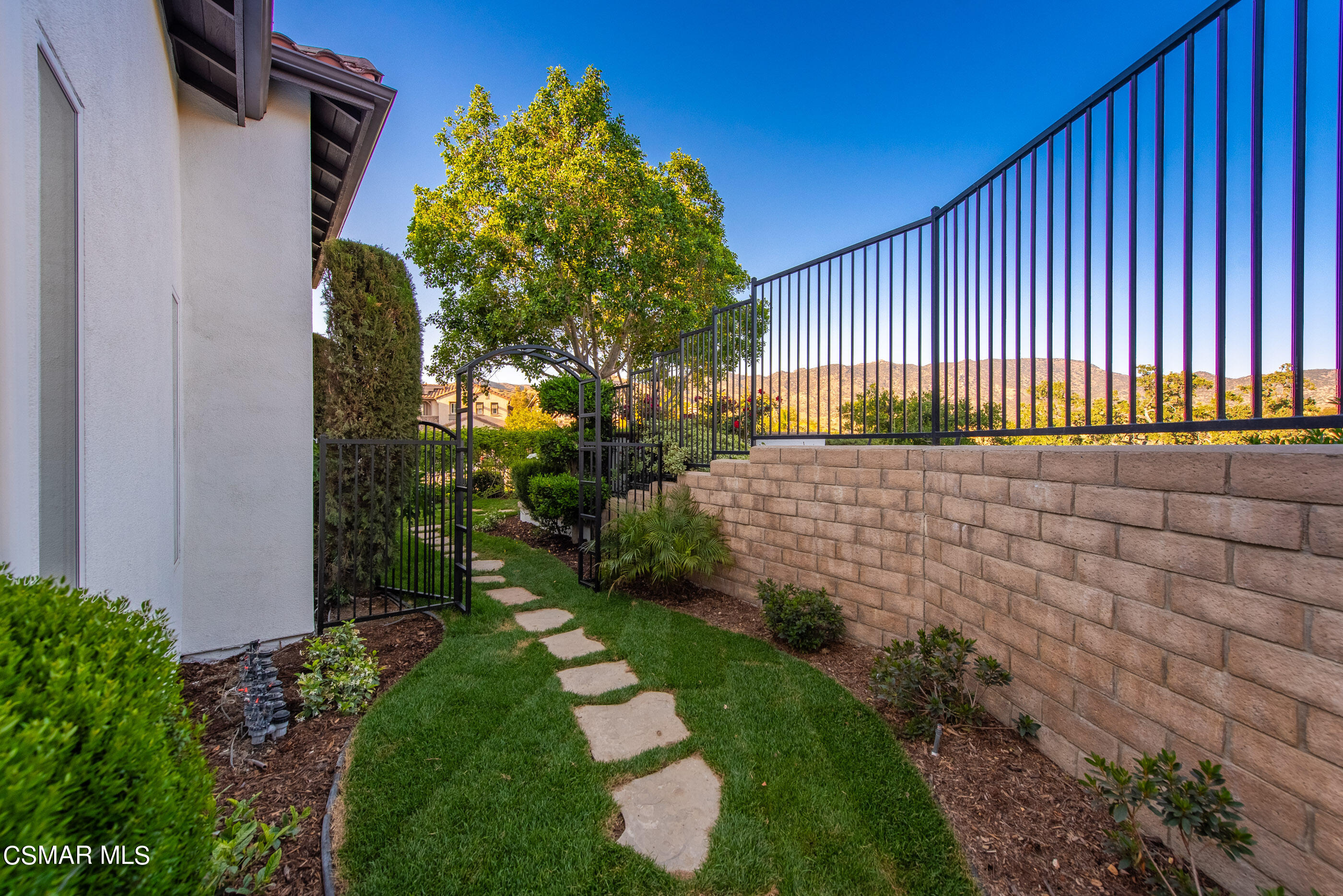 5984 Piuma Court Simi Valley, CA 93063 - Photo 55 of 70 a backyard of a house with plants and wooden fence