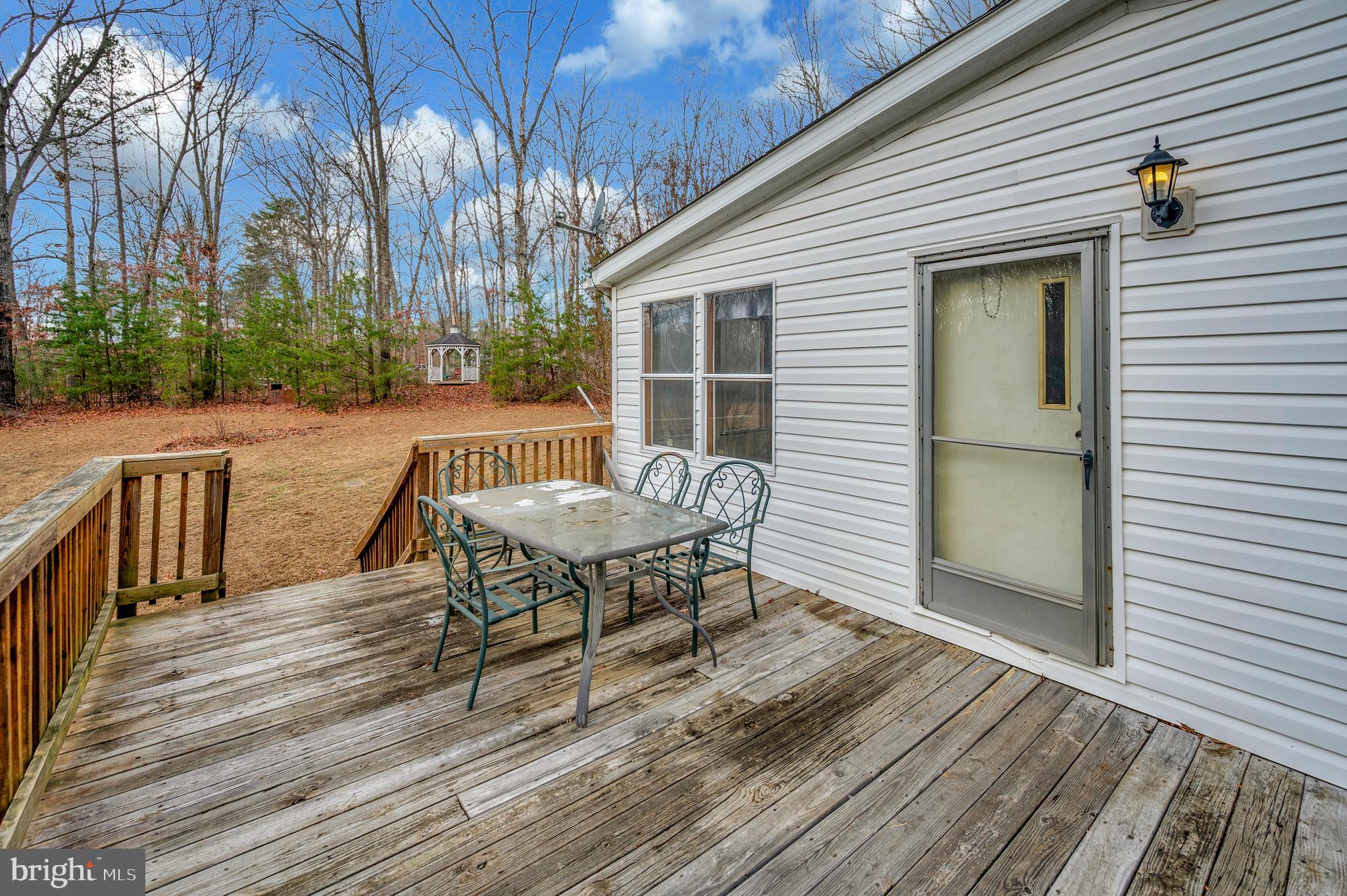 12619 Orange Plank Road Locust Grove, VA 22508 - Photo 15 of 43 a view of a patio with a table and chairs