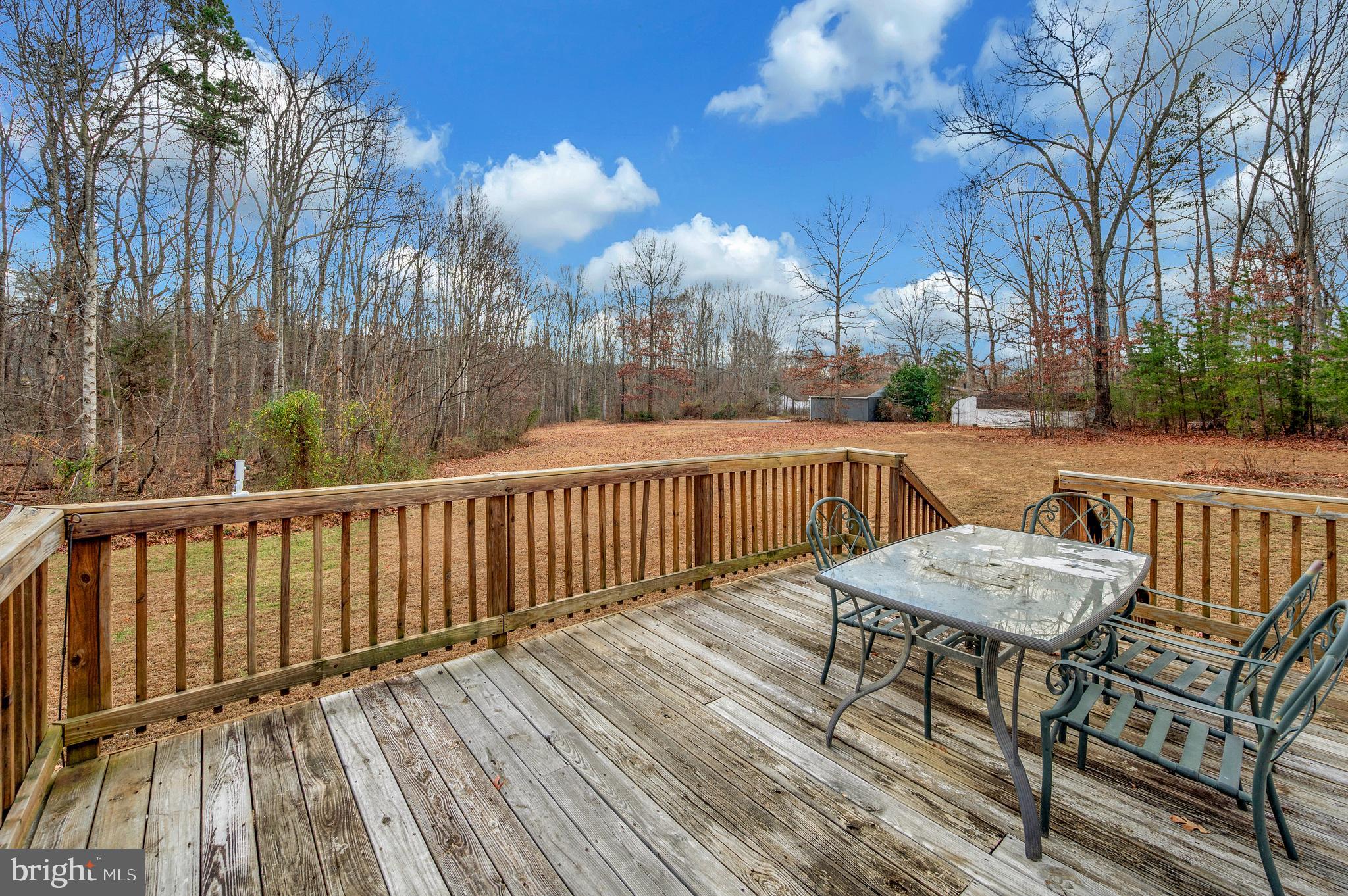 12619 Orange Plank Road Locust Grove, VA 22508 - Photo 16 of 43 a view of a patio on wooden deck and a backyard