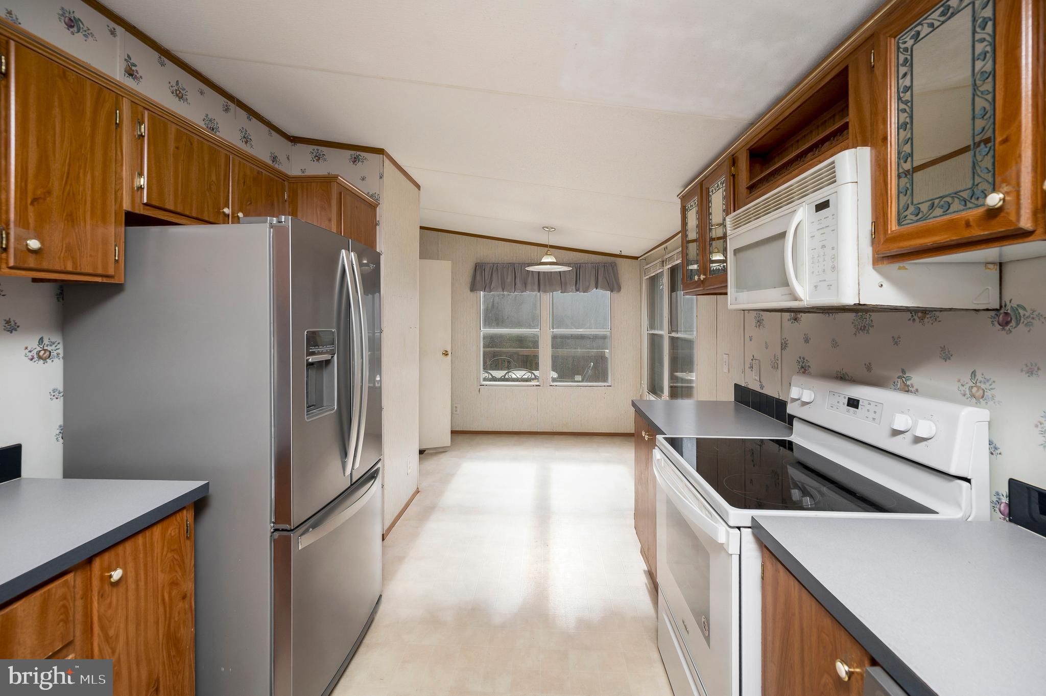 12619 Orange Plank Road Locust Grove, VA 22508 - Photo 17 of 43 a kitchen with stainless steel appliances sink a refrigerator and a stove
