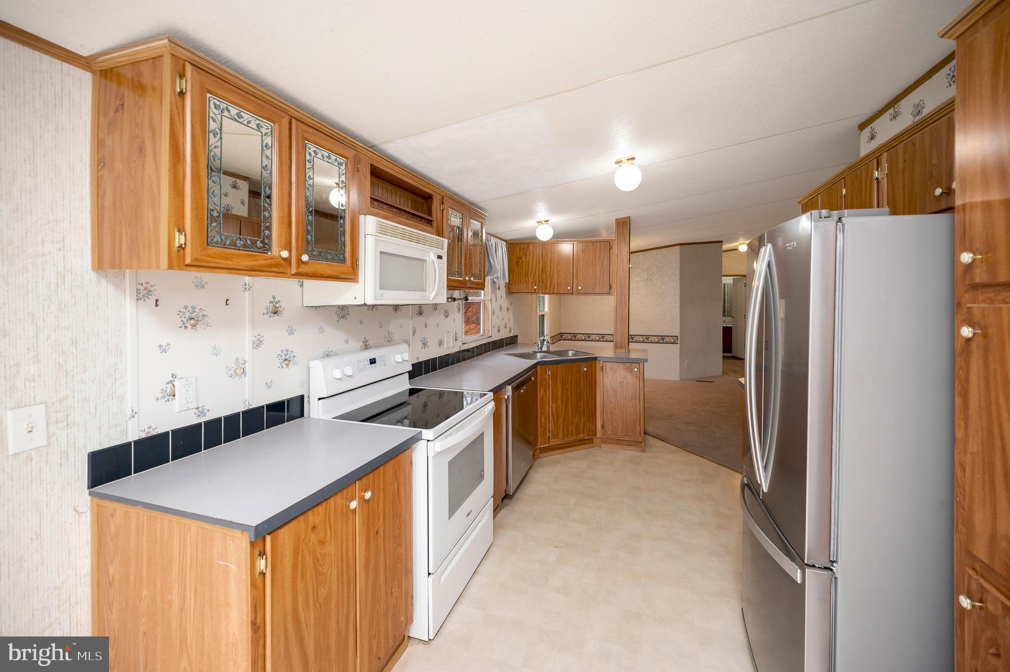 12619 Orange Plank Road Locust Grove, VA 22508 - Photo 18 of 43 a kitchen with stainless steel appliances granite countertop a refrigerator a sink a stove and a refrigerator
