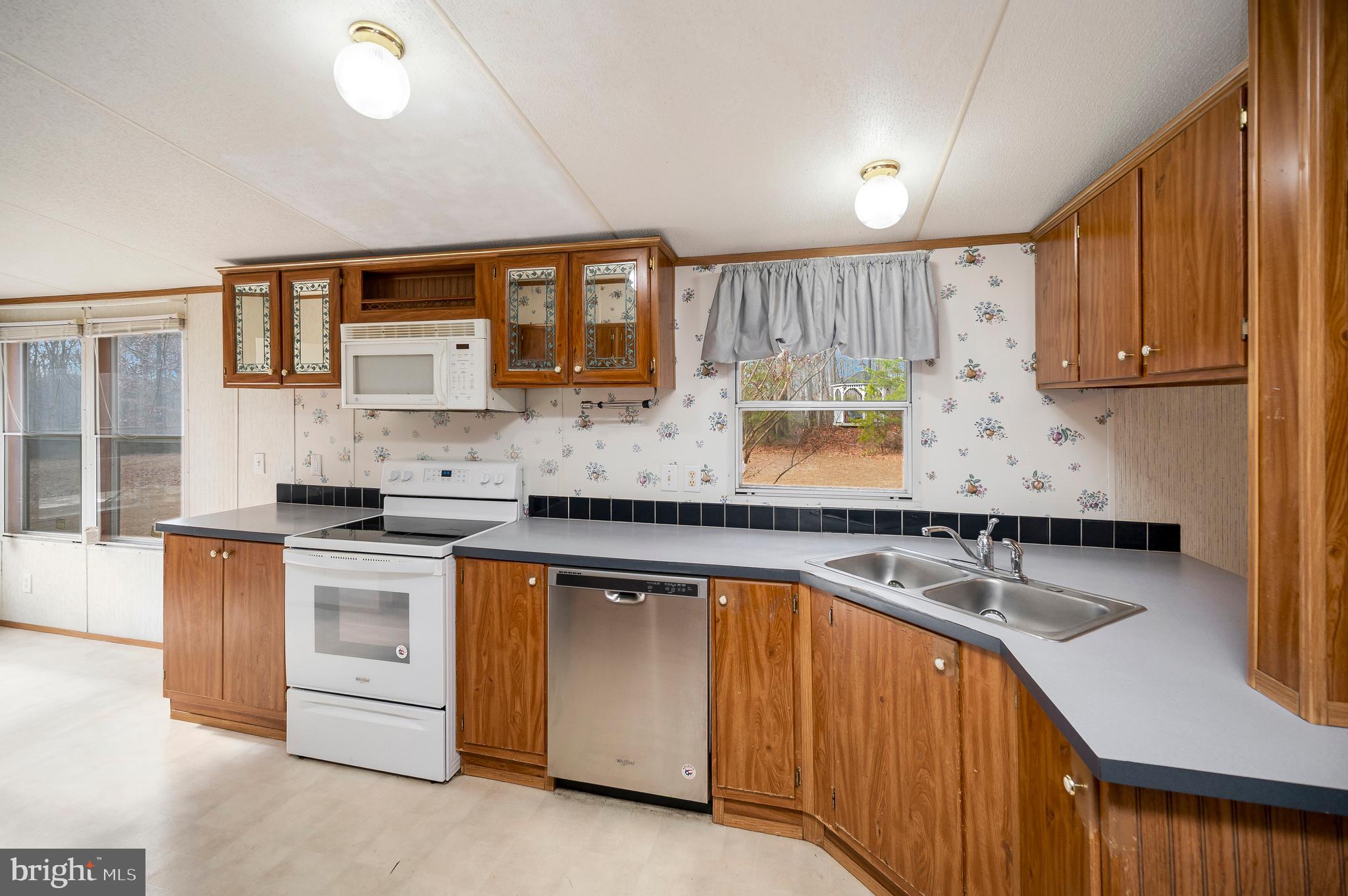 12619 Orange Plank Road Locust Grove, VA 22508 - Photo 20 of 43 a kitchen with stainless steel appliances granite countertop a sink stove and cabinets