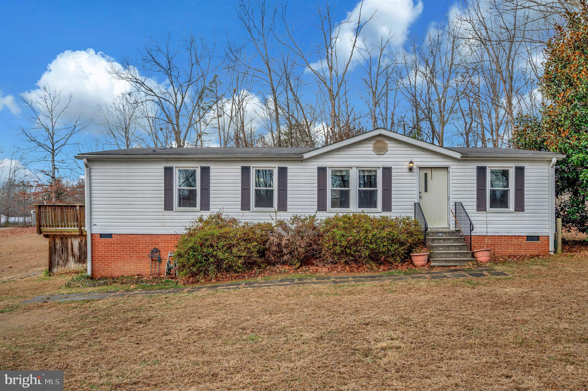 12619 Orange Plank Road Locust Grove, VA 22508 - Photo 2 of 43 a front view of house with yard and trees around