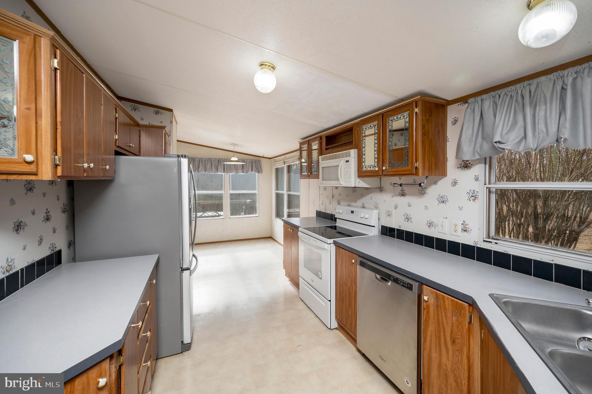12619 Orange Plank Road Locust Grove, VA 22508 - Photo 22 of 43 a kitchen with stainless steel appliances granite countertop a sink stove and cabinets