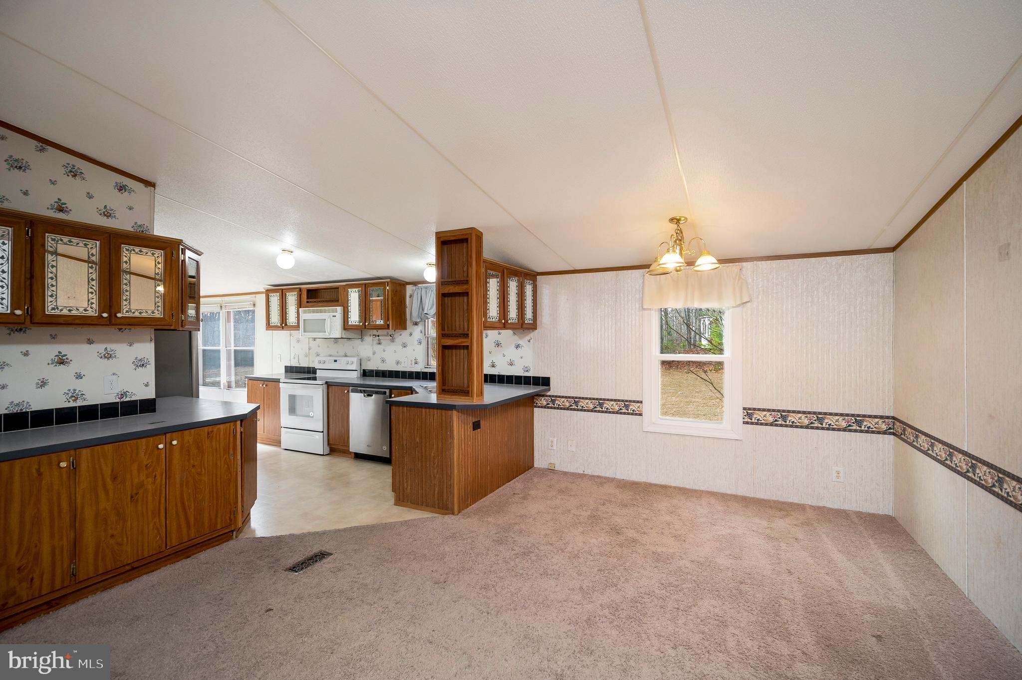 12619 Orange Plank Road Locust Grove, VA 22508 - Photo 24 of 43 a large kitchen with stainless steel appliances granite countertop a sink and cabinets