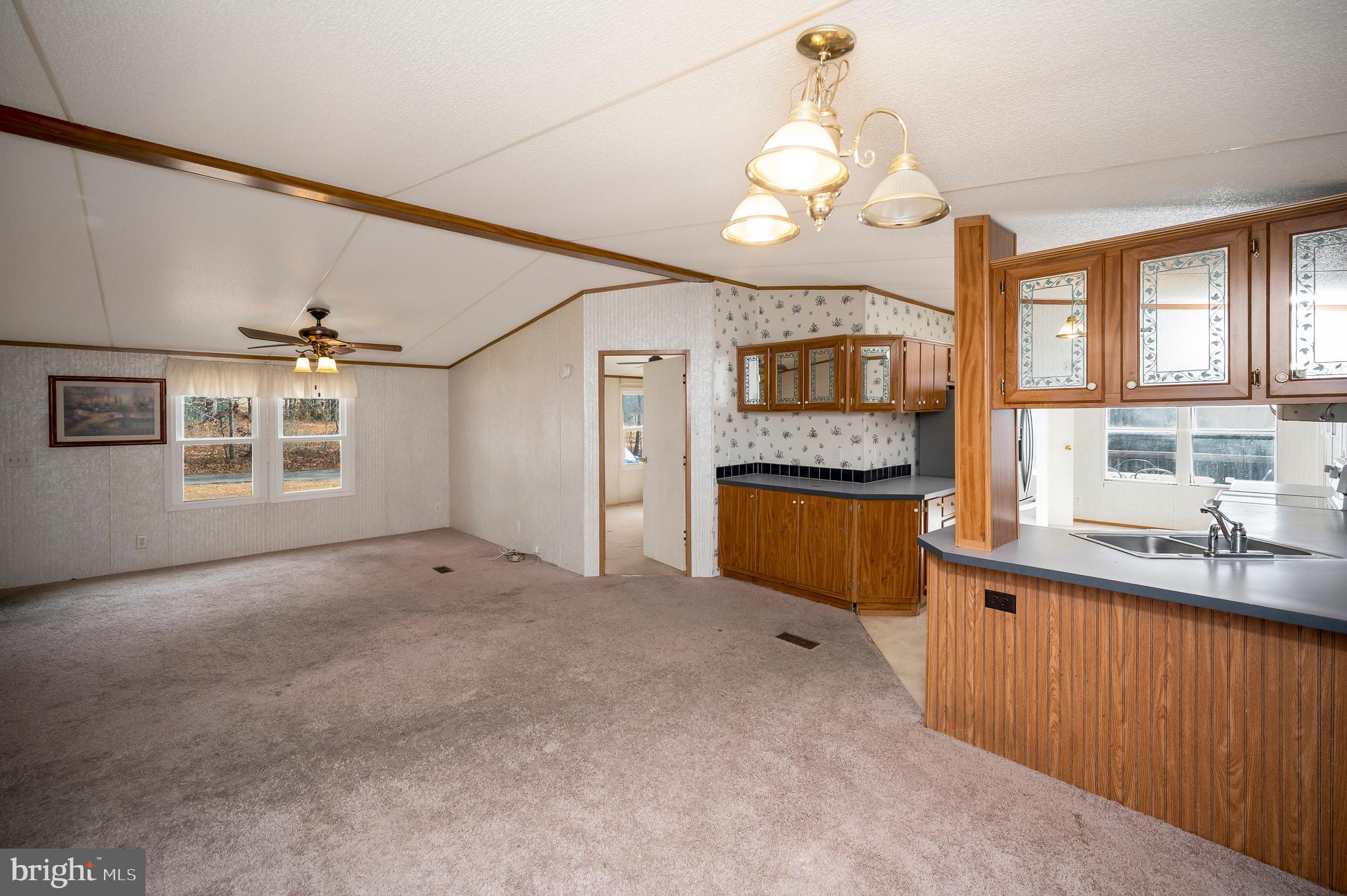 12619 Orange Plank Road Locust Grove, VA 22508 - Photo 26 of 43 a view of a kitchen with a sink and dishwasher cabinet with wooden floor