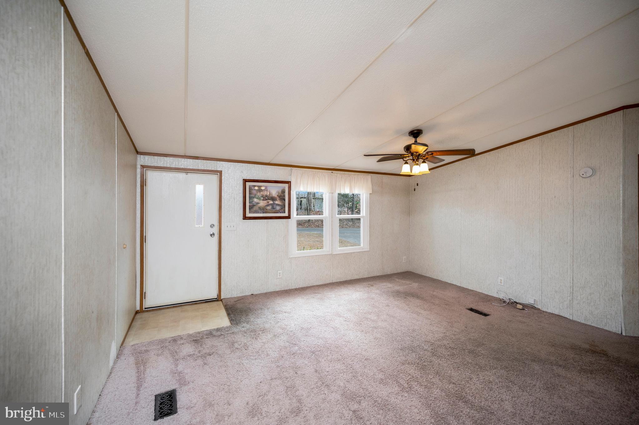 12619 Orange Plank Road Locust Grove, VA 22508 - Photo 28 of 43 an empty room with windows and ceiling fan