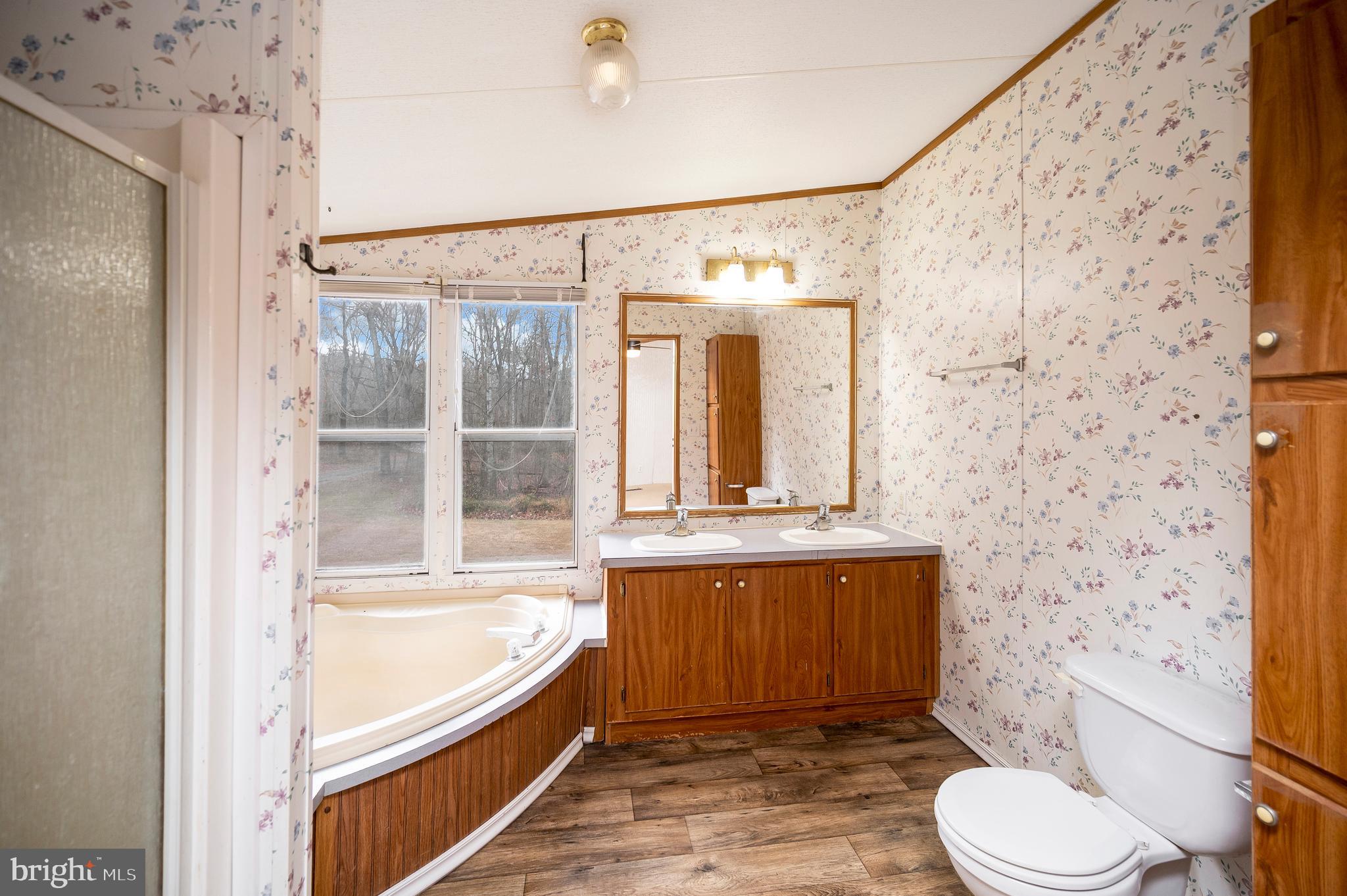12619 Orange Plank Road Locust Grove, VA 22508 - Photo 37 of 43 a bathroom with a granite countertop bathtub toilet and sink