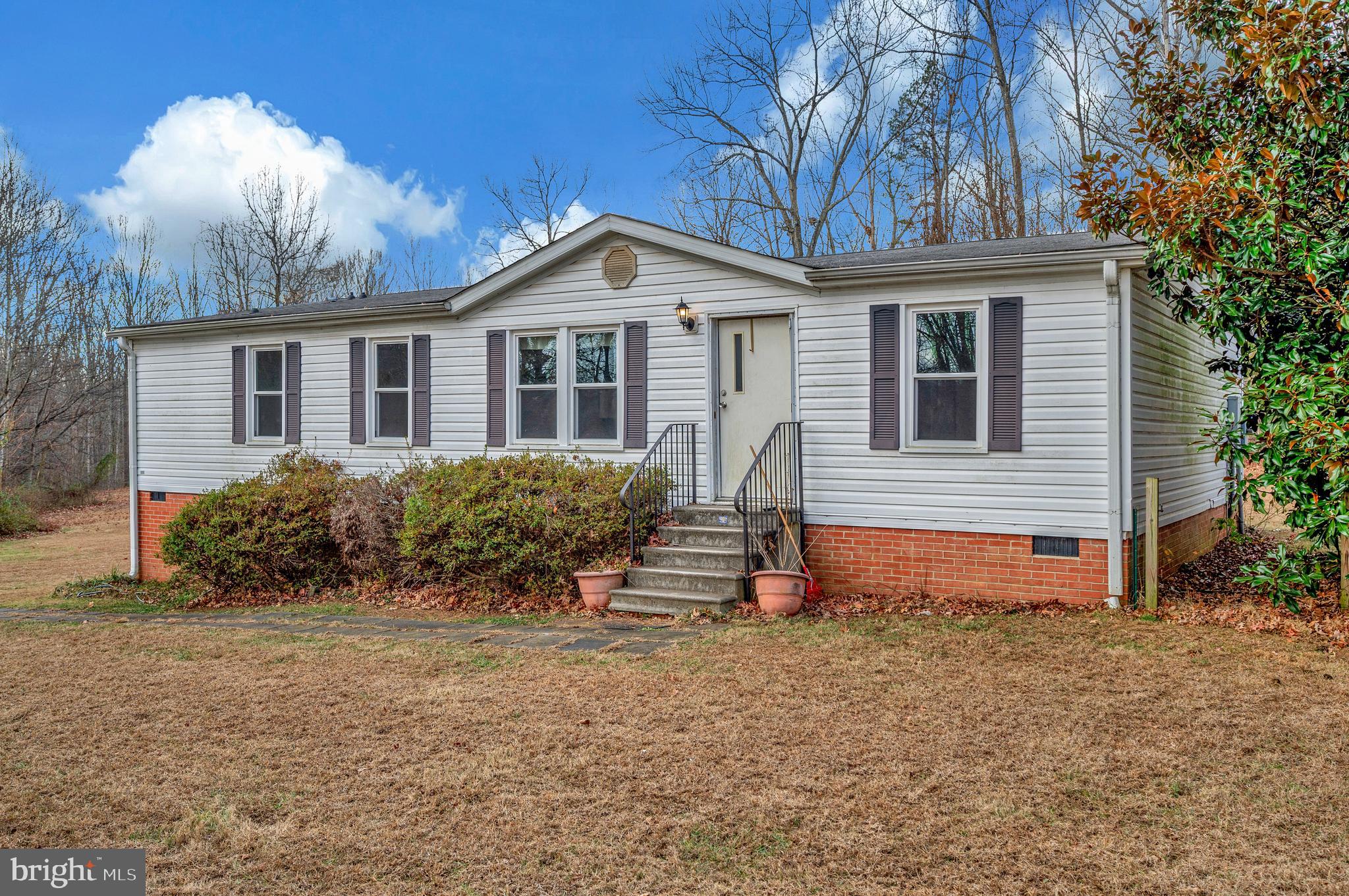 12619 Orange Plank Road Locust Grove, VA 22508 - Photo 4 of 43 a front view of a house with a yard