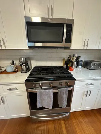 a kitchen with a sink a stove and cabinets