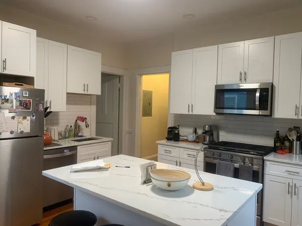 a bathroom with a sink a toilet and a shower