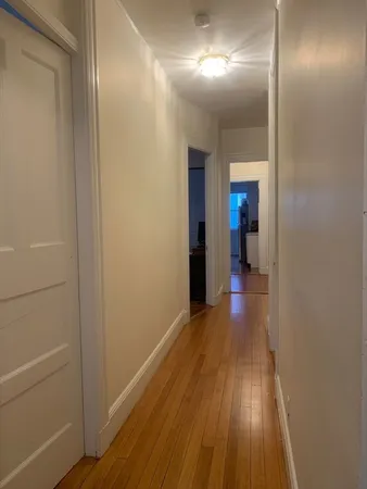 a view of hallway with wooden floor