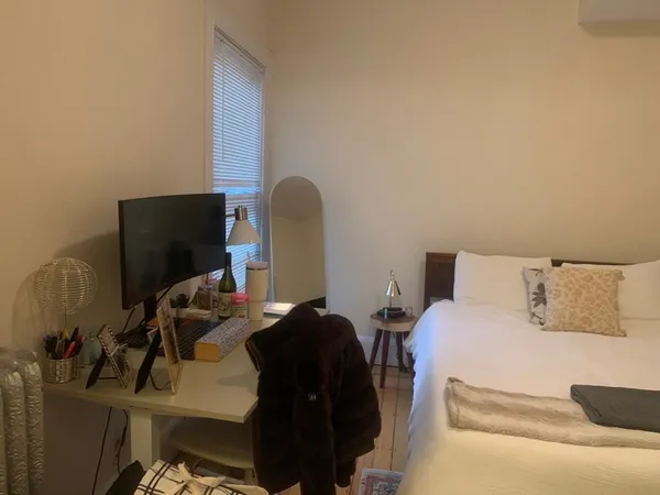 a bedroom with a bed and a lamp