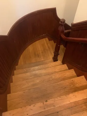 a view of hallway with wooden floor