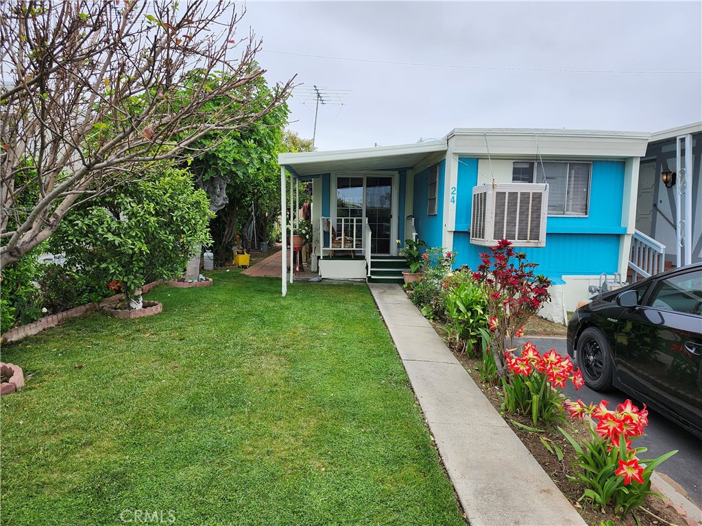 a front view of a house with a yard and fountain