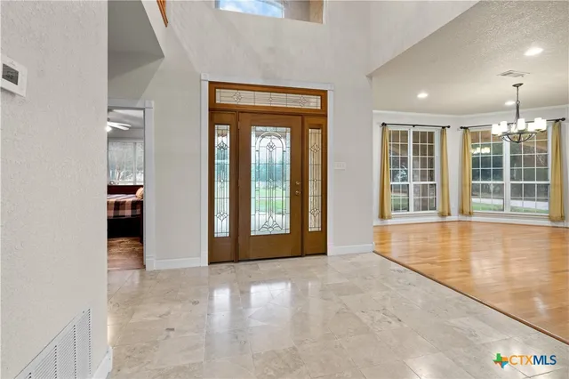 a view of an empty room with a fireplace and a window