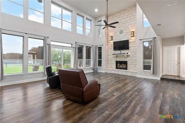 a living room with furniture fireplace and flat screen tv