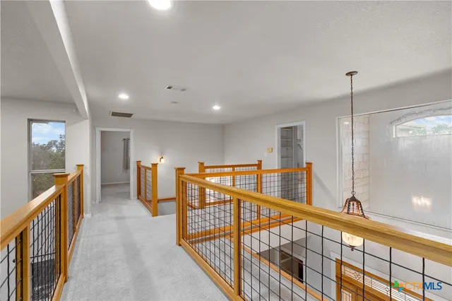 a view of a living room with a flat screen tv and a floor to ceiling window