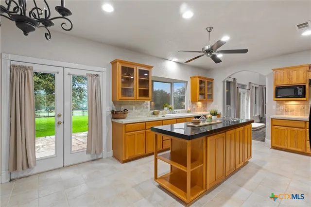 a kitchen with a stove a sink and a refrigerator