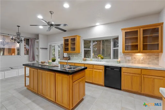 a kitchen with stainless steel appliances granite countertop a sink and cabinets