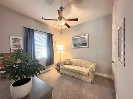 a living room with furniture and potted plant
