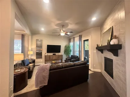 a living room with furniture a fireplace and a flat screen tv