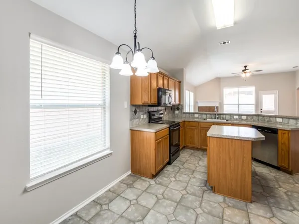 a kitchen with a sink stove and cabinets