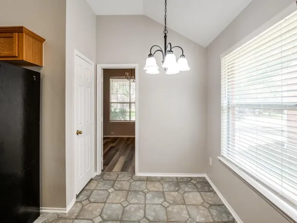 a large kitchen with stainless steel appliances granite countertop a stove a sink dishwasher and a refrigerator