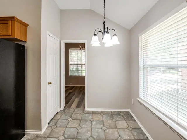 a large kitchen with stainless steel appliances granite countertop a stove a sink dishwasher and a refrigerator