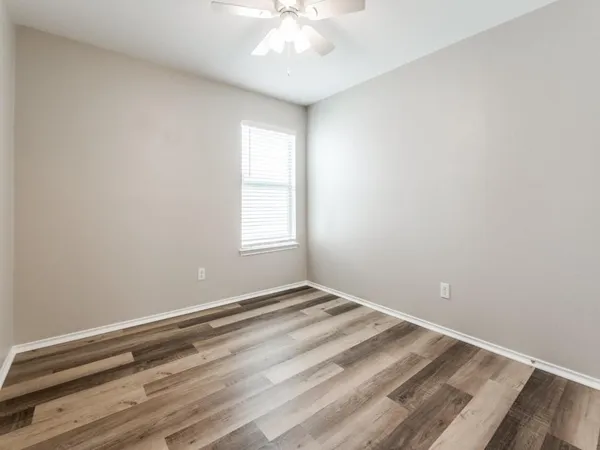 a view of room with window and ceiling fan