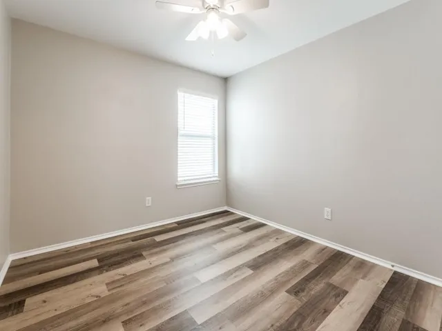 a view of room with window and ceiling fan