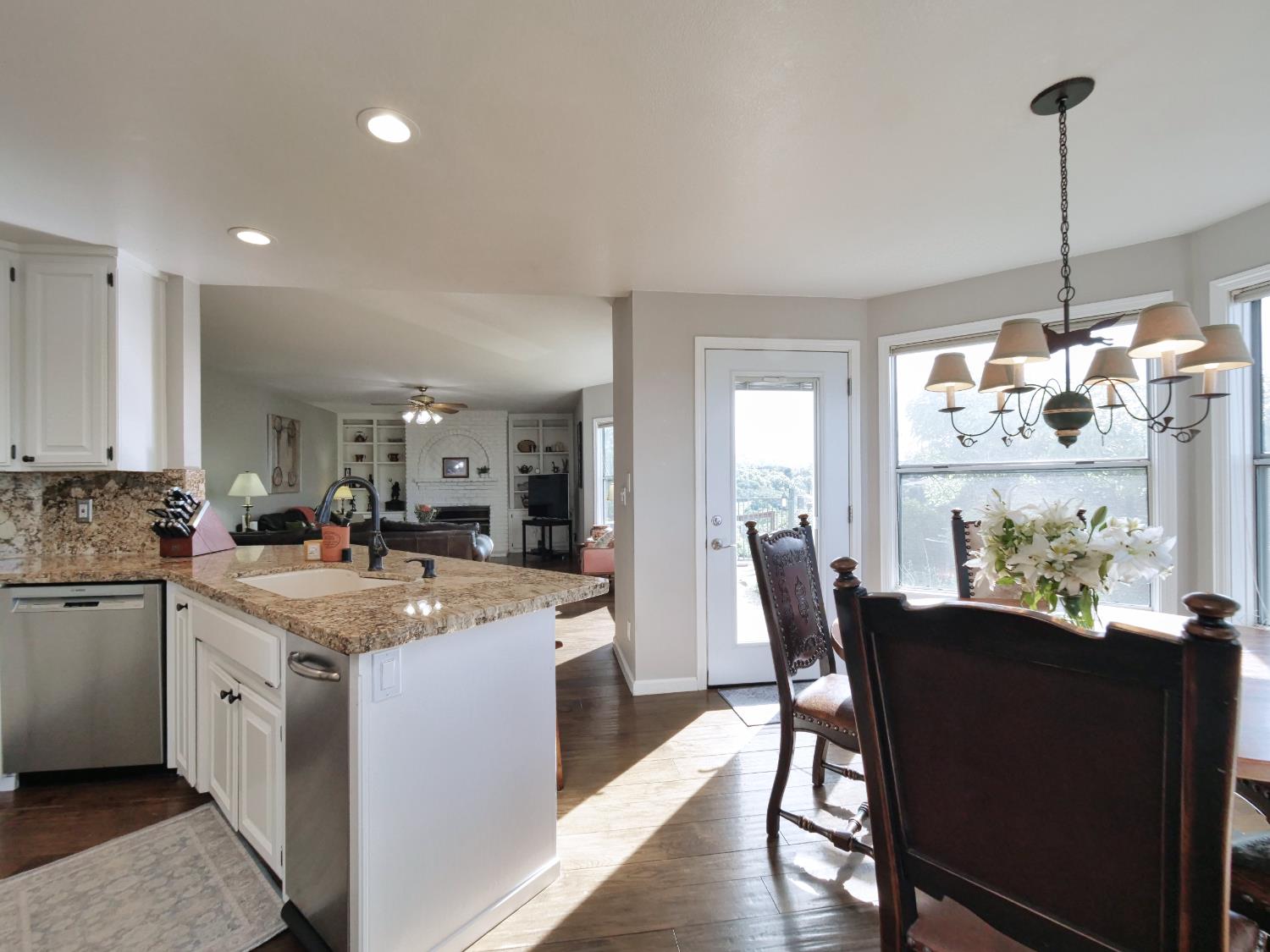 2405 Greensboro Road Placerville, CA 95667 - Photo 20 of 99 a room with stainless steel appliances kitchen island granite countertop a sink a stove and a dining table