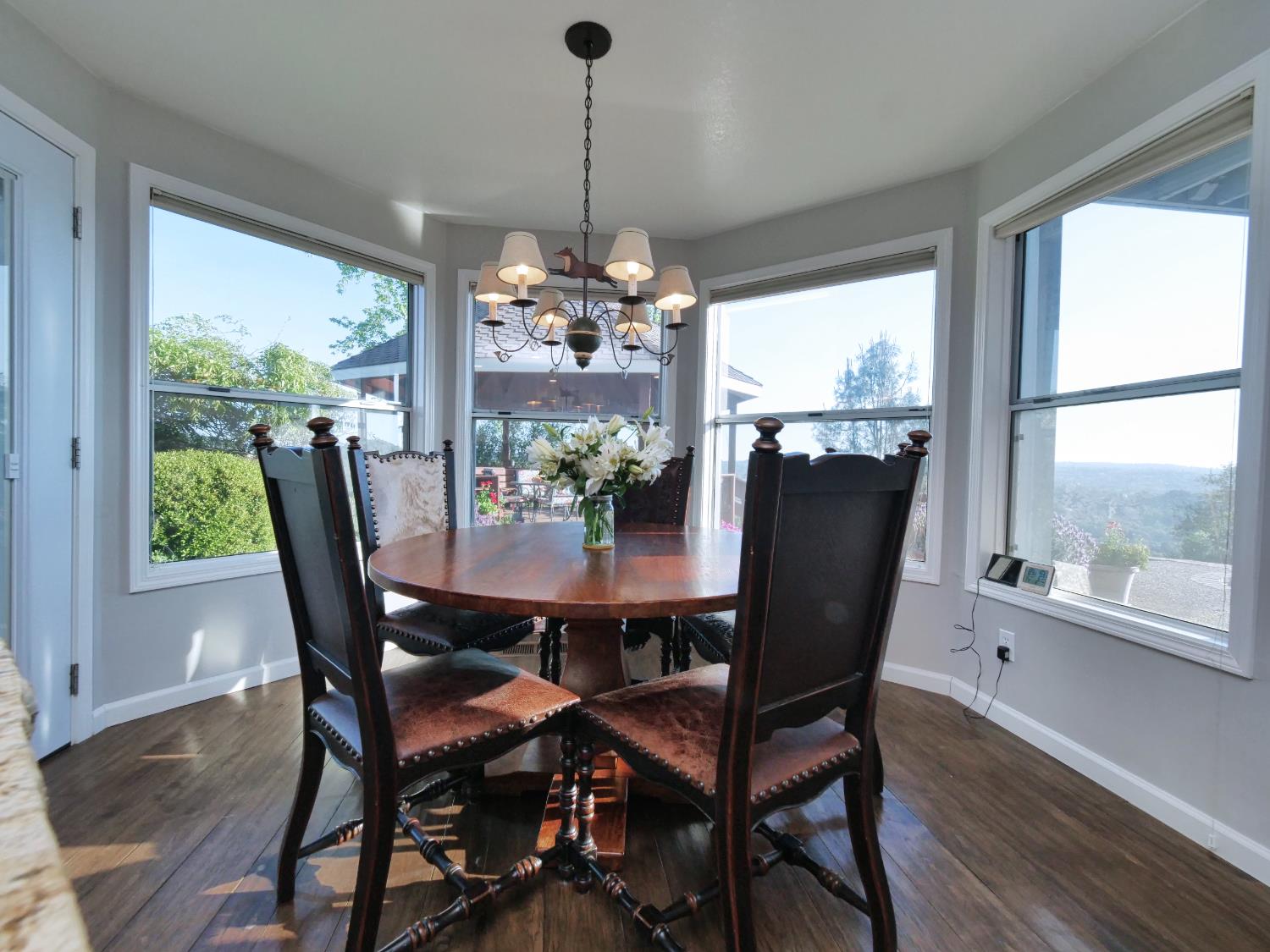 2405 Greensboro Road Placerville, CA 95667 - Photo 21 of 99 a dining room with furniture a chandelier and wooden floor