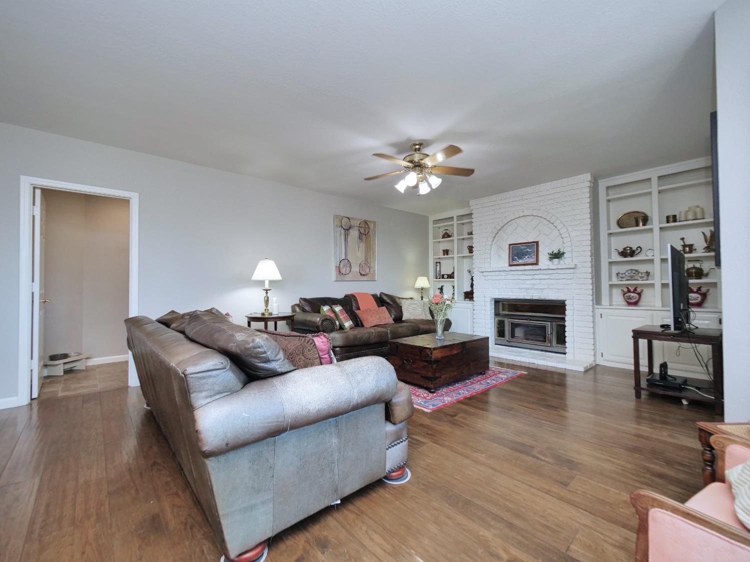 2405 Greensboro Road Placerville, CA 95667 - Photo 23 of 99 a living room with furniture a fireplace and a ceiling fan