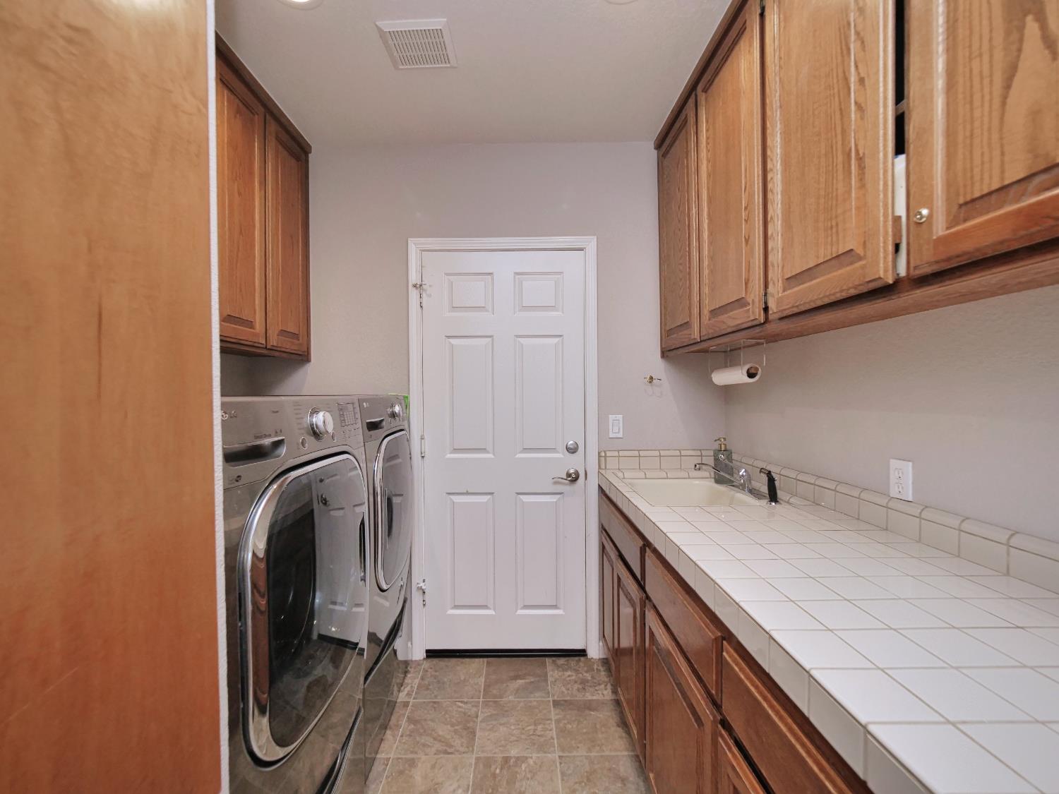 2405 Greensboro Road Placerville, CA 95667 - Photo 28 of 99 a utility room with a sink a washer and dryer