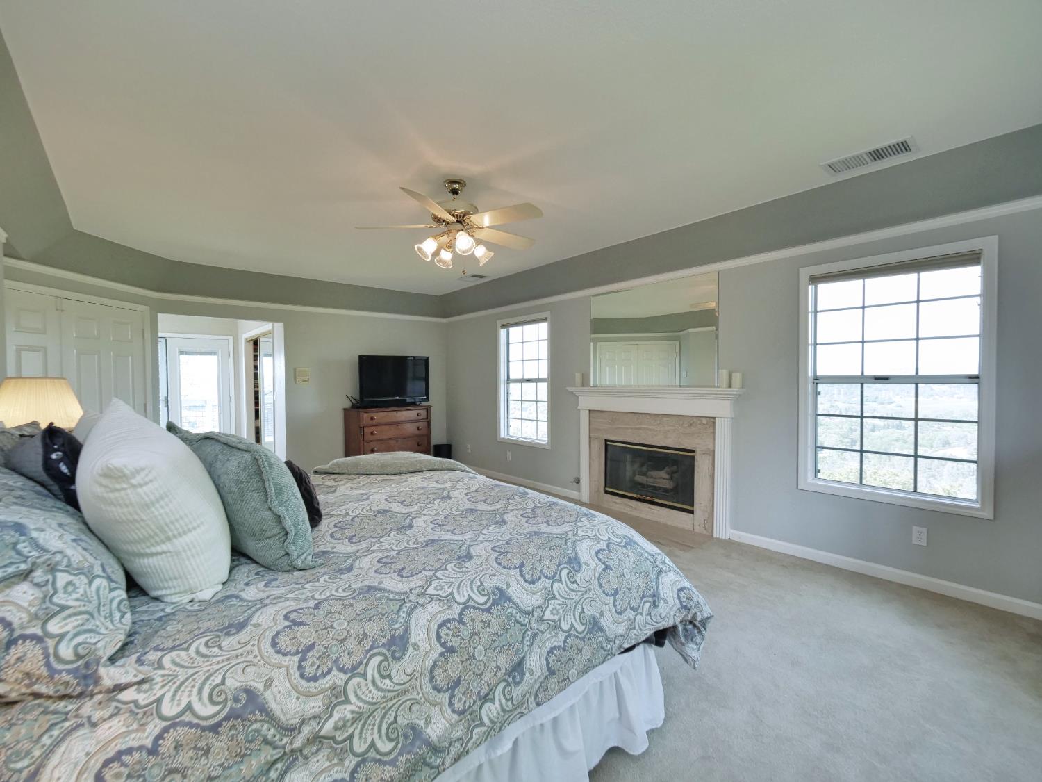 2405 Greensboro Road Placerville, CA 95667 - Photo 34 of 99 a spacious bedroom with a large bed and a fireplace