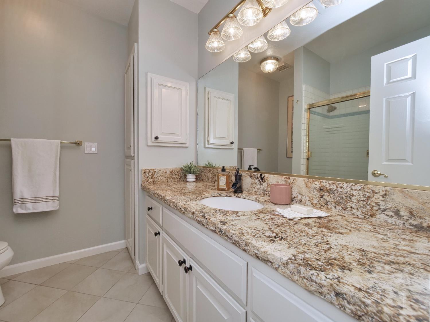 2405 Greensboro Road Placerville, CA 95667 - Photo 44 of 99 a bathroom with a granite countertop sink and a mirror