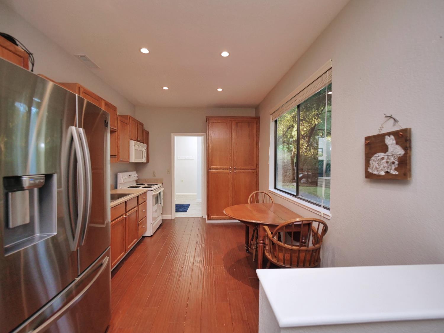 2405 Greensboro Road Placerville, CA 95667 - Photo 70 of 99 a kitchen with stainless steel appliances wooden floor and a refrigerator