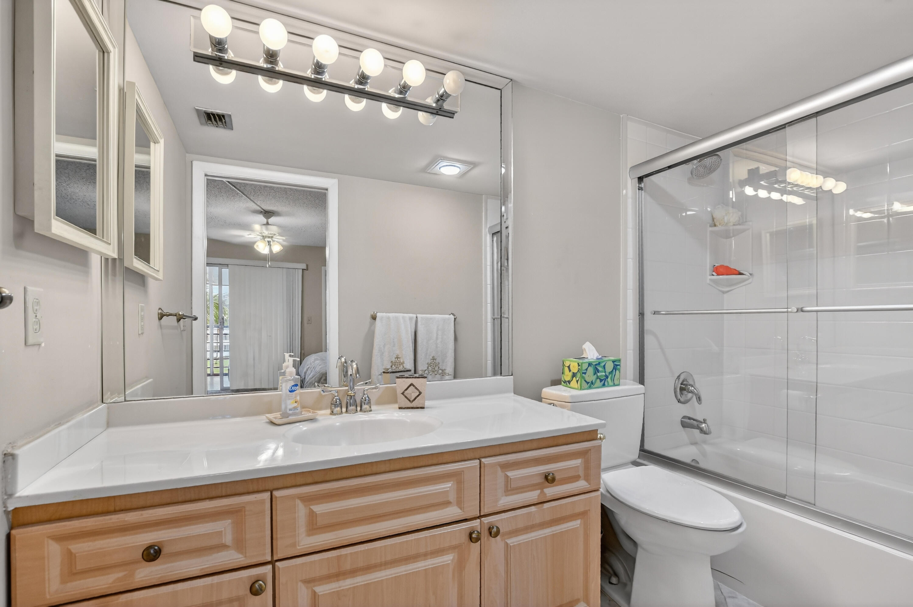 3009 Yarmouth C, Unit 3009 Boca Raton, FL 33434 - Photo 12 of 75 a bathroom with a sink a toilet and shower