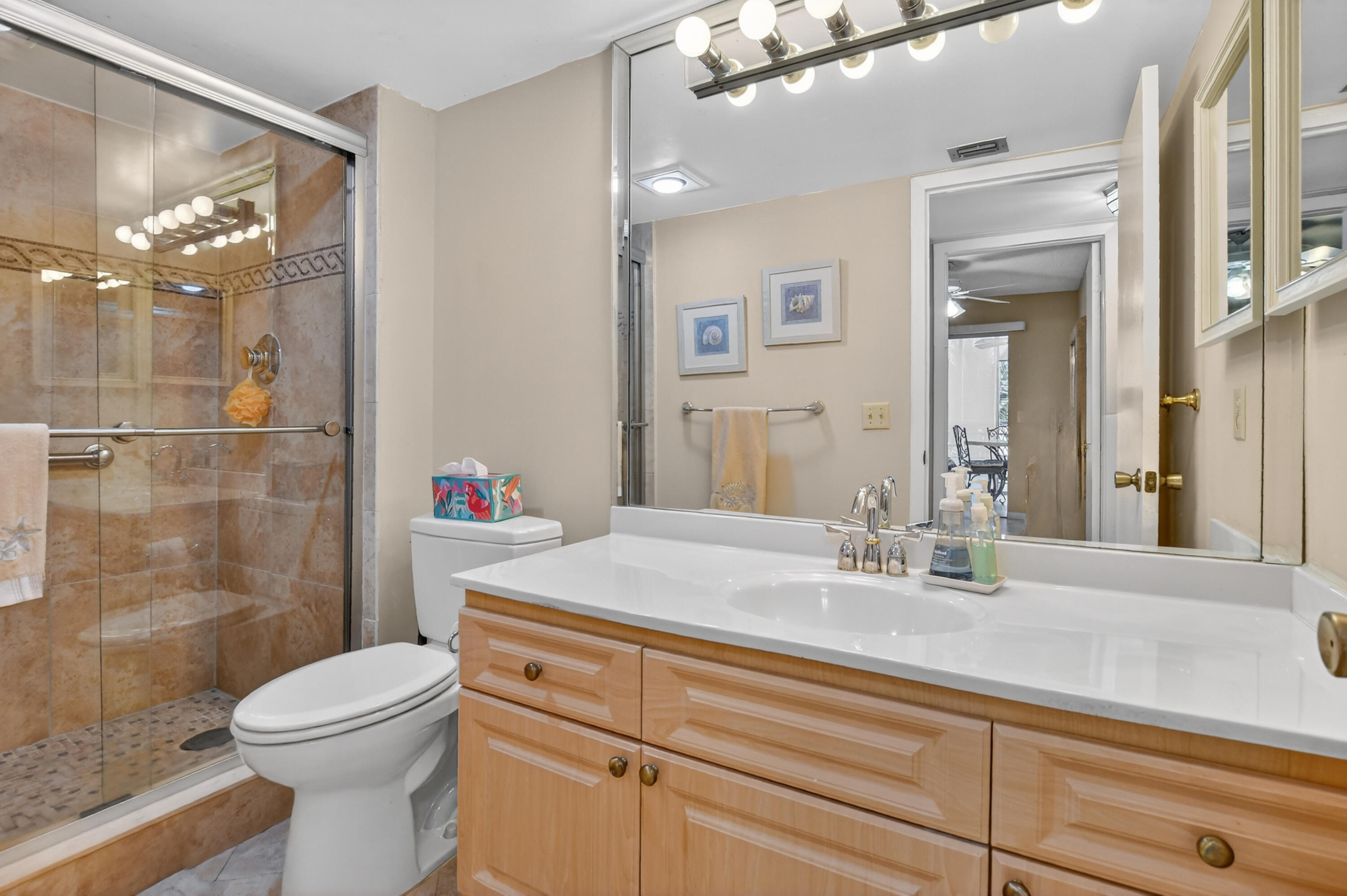 3009 Yarmouth C, Unit 3009 Boca Raton, FL 33434 - Photo 16 of 75 a bathroom with a sink a toilet and shower