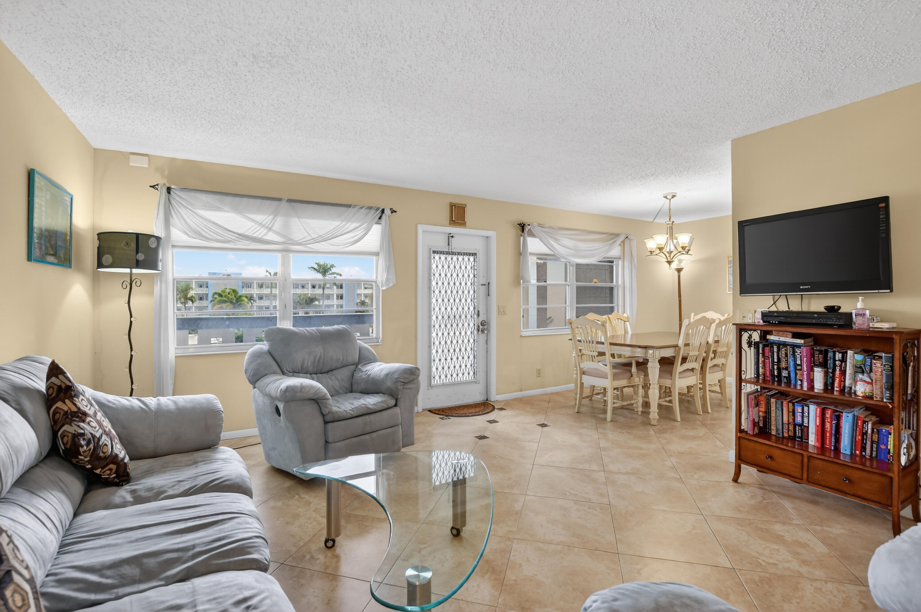 3009 Yarmouth C, Unit 3009 Boca Raton, FL 33434 - Photo 4 of 75 a living room with furniture and a flat screen tv