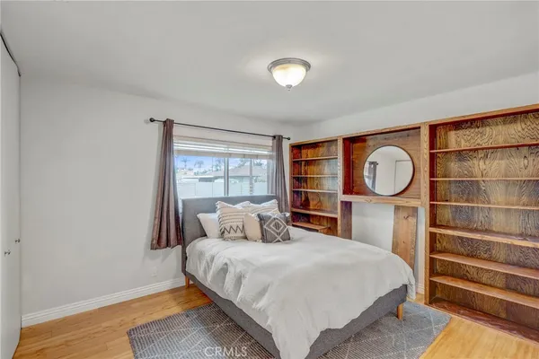 a bedroom with a bed and a window